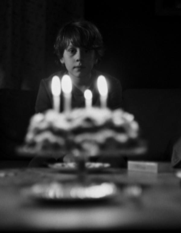 Jeremy behind a birthday cake