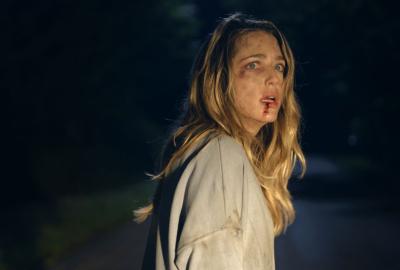 Film still from the Opening Night Film Affection: woman with bloody face looks back