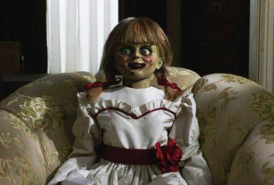 Annabelle sits on a sofa