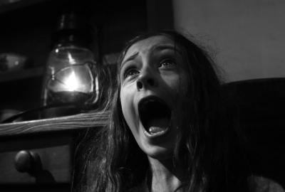 A young girl, screaming in fear.