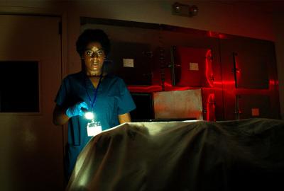 Wake film still woman with a flashlight searches for something