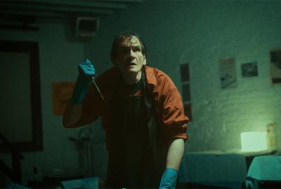 Man holding surgical tool in secret lab
