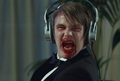 Frostbitten bloody faced man with headphones screams