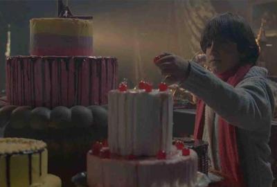 Boy taking candy from a cake