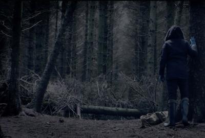 nsfw film still man looking for something in the woods