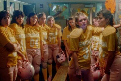 female football team stands in locker room