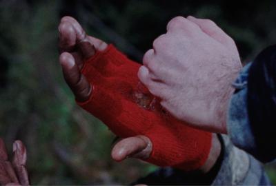 A gloved hand getting pushed